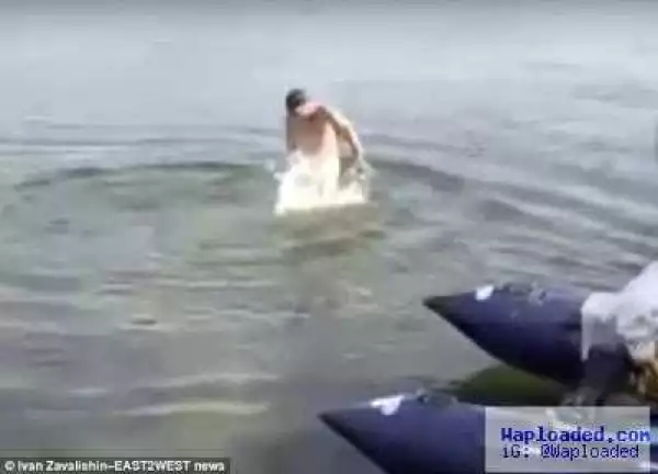 Naked swimmer rushes out of lake after fish 